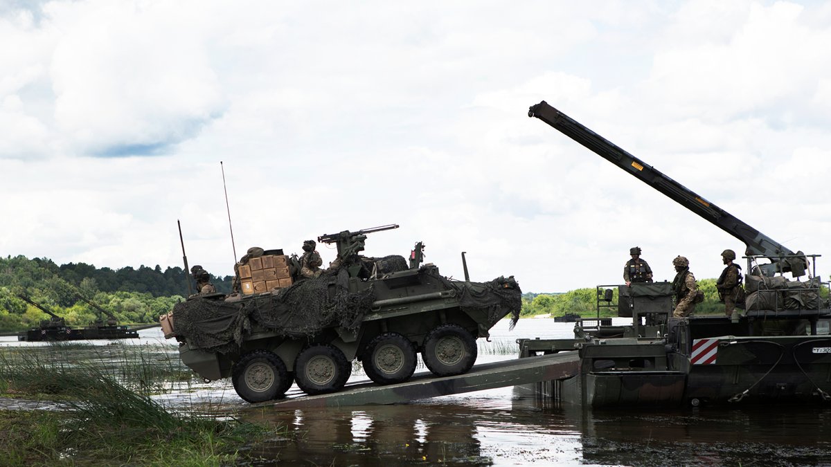 German and British bridging equipment is used to move  @USArmy Stryker vehicles across a river in Lithuania during SaberStrike 18